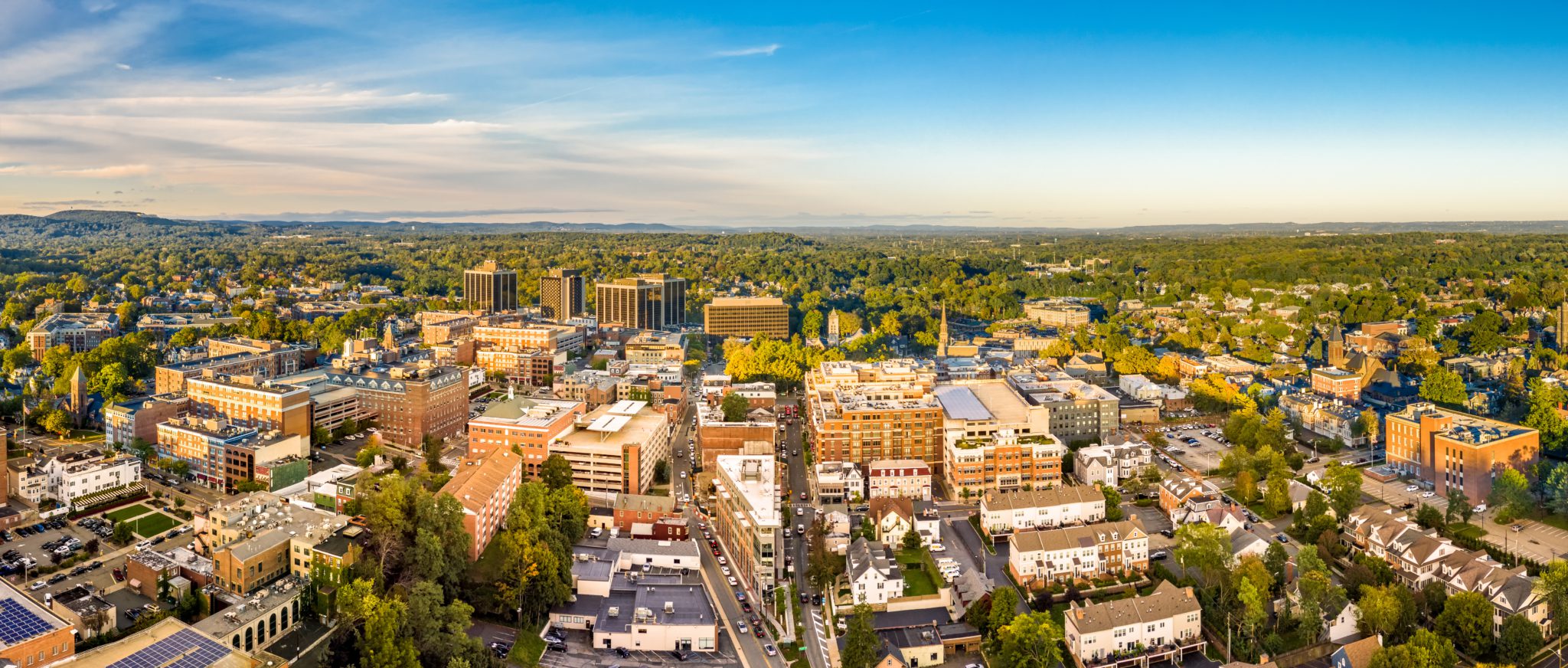 Aerial panorama of city skyline on late sunny afternoon.